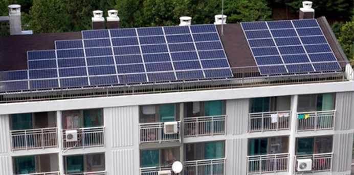 Apartment building with solar panels installed on the rooftop