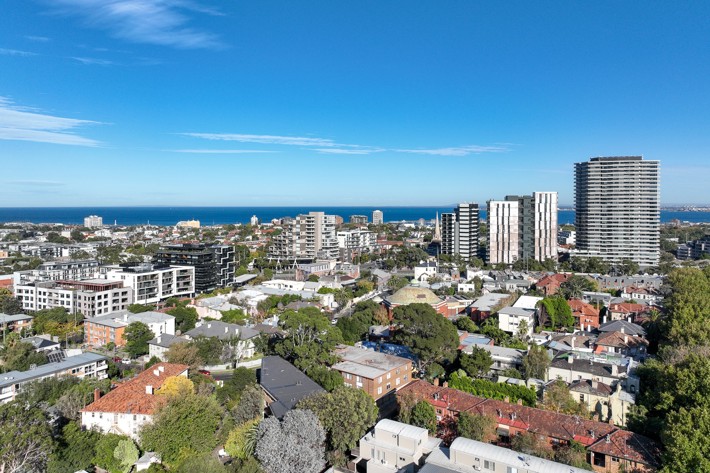 An aerial photo of Port Phillip, showing high rise apartment buildings and smaller multi-unit dwellings. Lots of trees are visible between buildings. 